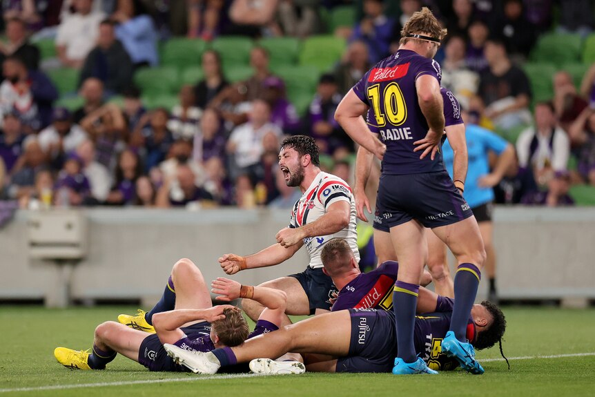 A man celebrates after scoring a try in a rugby league match