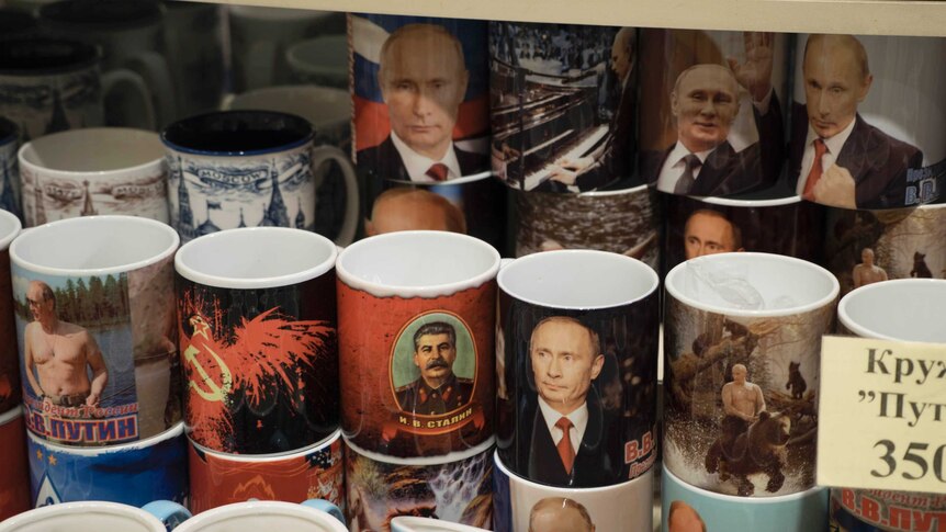 Souvenir mugs depict Russian President Vladimir Putin