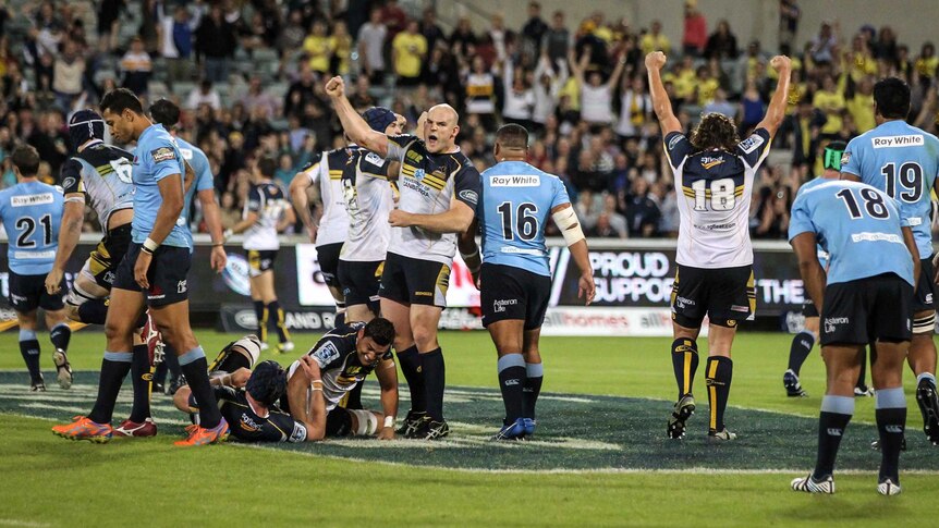 Brumbies' player Stephen Moore punches the air after the Brumbies scored a try against the Waratahs.