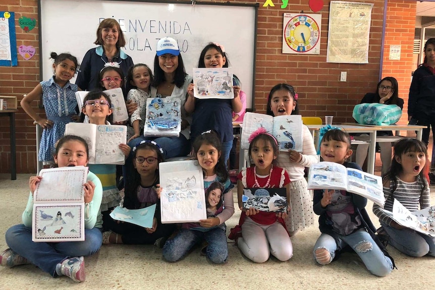 Colombian girls with drawings of penguins