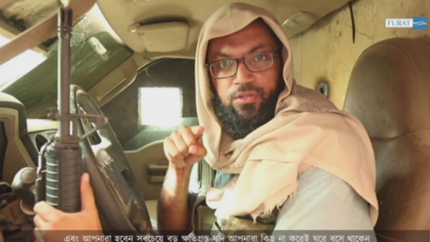 Neaz Morshed Raja with machine gun in hand addresses the camera in an IS video