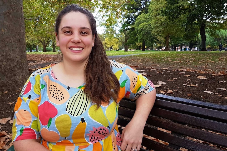 A photo of Alison Marshall sitting on a bench.