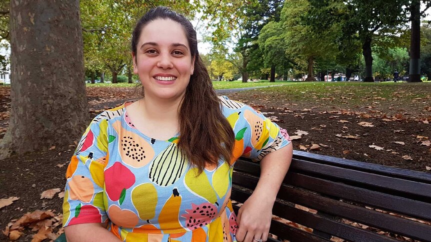 A photo of Alison Marshall sitting on a bench.