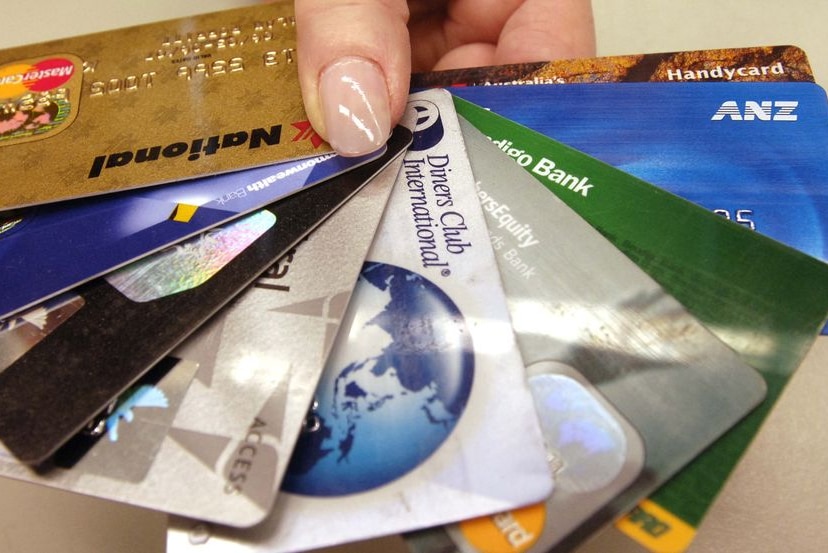 A hand holds numerous credit cards (file image: AAP)