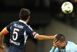 Mark Milligan of Victory and Terry Antonis of Sydney collide during the round 11 A-League match between Melbourne Victory and Sydney FC