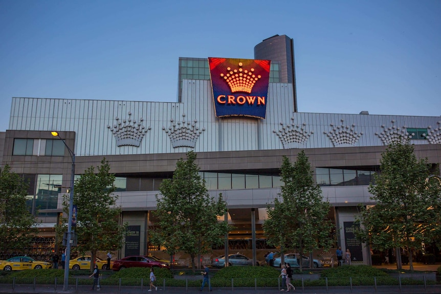 A neon sign glows on the Crown Casino building in Melbourne