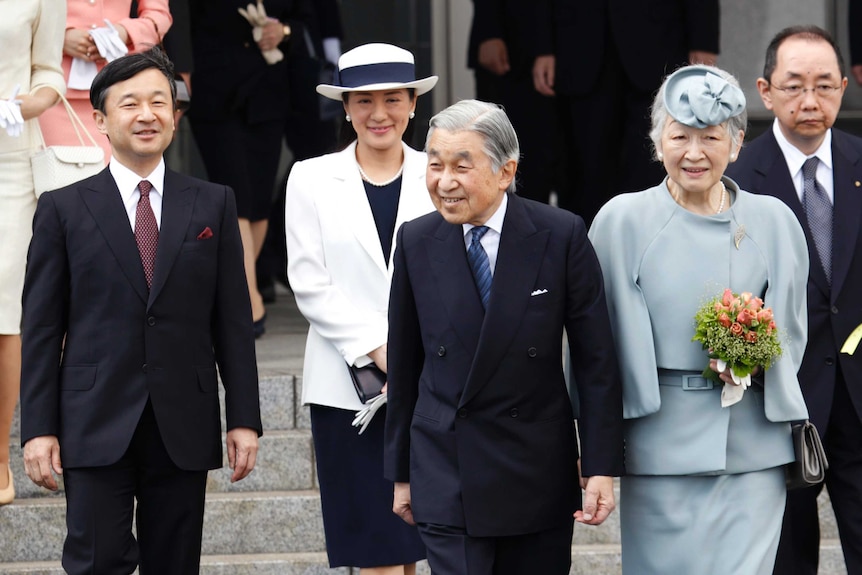 Japanese Emperor Akihito and Crown Prince Naruhito wear suits.
