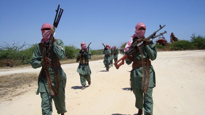 Militants of al Shabaab train with weapons on a street in the outskirts of Mogadishu