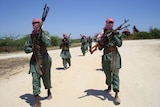 Militants of al Shabaab train with weapons on a street in the outskirts of Mogadishu