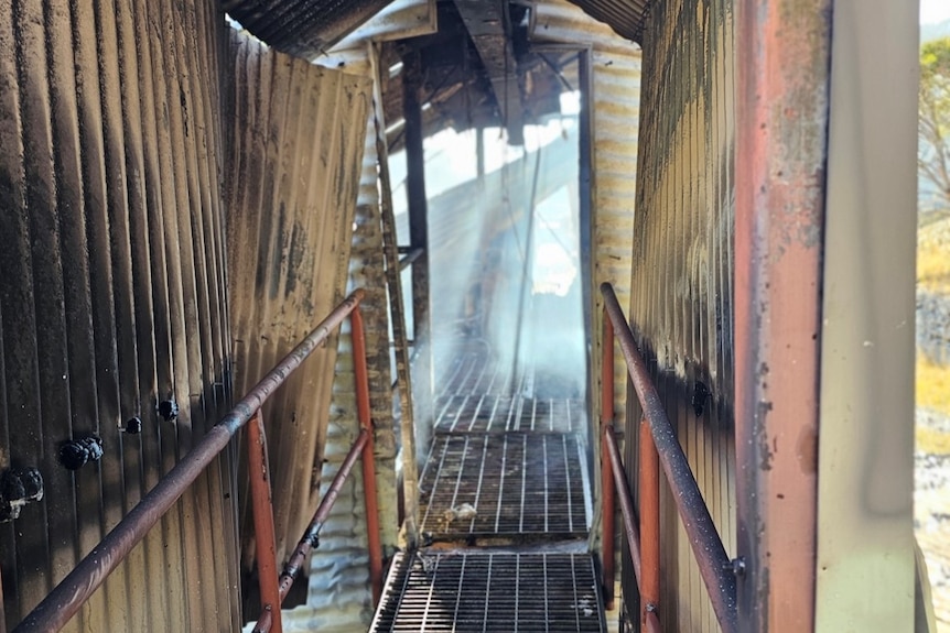 A walkway inside a building that has been damaged by fire.