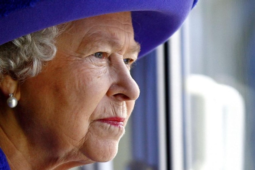 Britain's Queen Elizabeth II looks out from a window