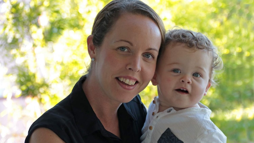 Woman holding her 12 month old daughter