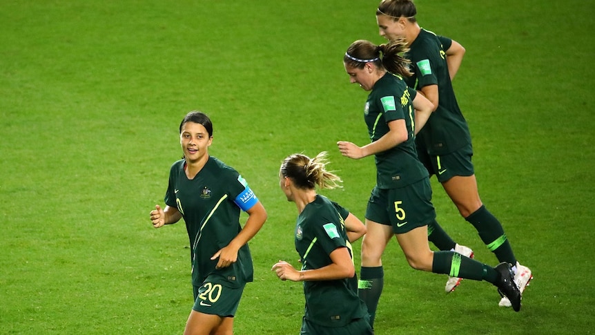 Four Matildas players job on green grass