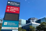 signage outside hospital with blue sky