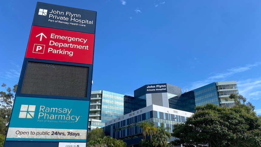 signage outside hospital with blue sky