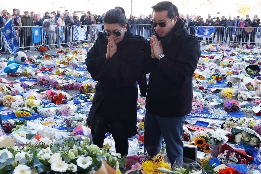 Leicester City's owner's wife and son lay wreath.