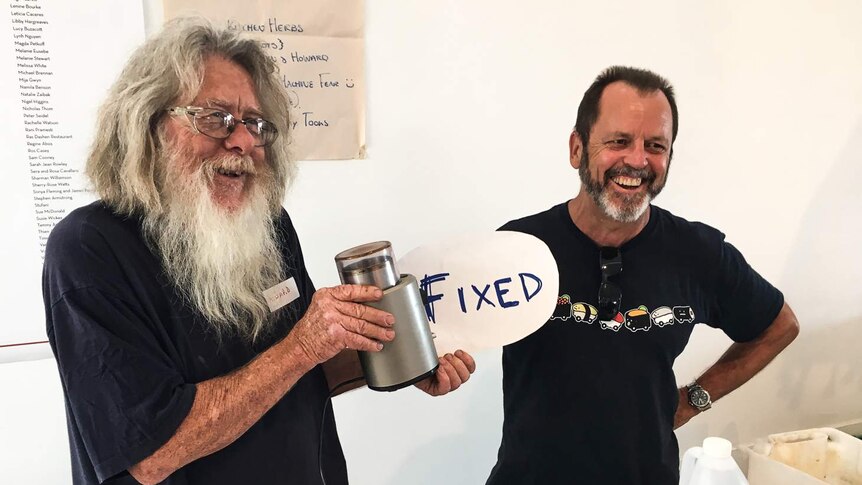 Howard (left) fixed a broken coffee grinder at the Melbourne Repair Cafe.