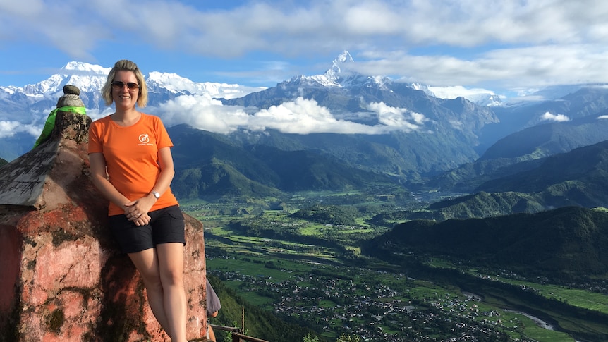 Lisa Pagotto standing atop a mountain in Nepal