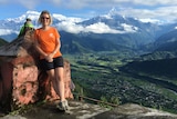 Lisa Pagotto standing atop a mountain in Nepal