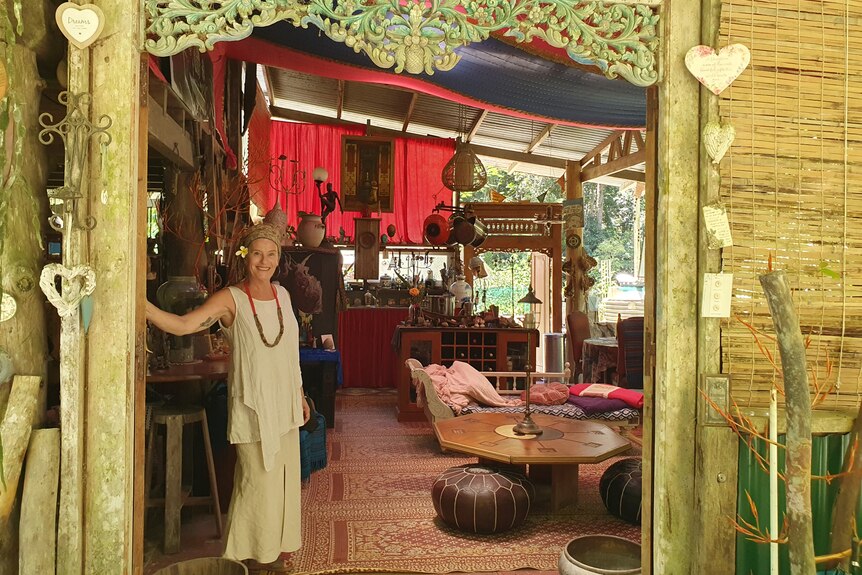 Lady standing at the entrance to her home with a Balinese door frame