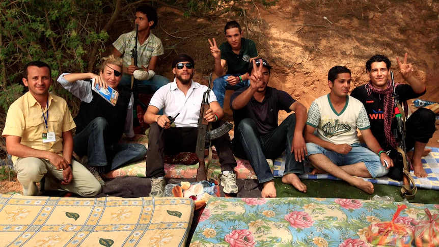 Sunday Times war correspondent Marie Colvin (second left) poses with Libyan rebels in Misrata, 2011. (Reuters: Zohra Bensemra)