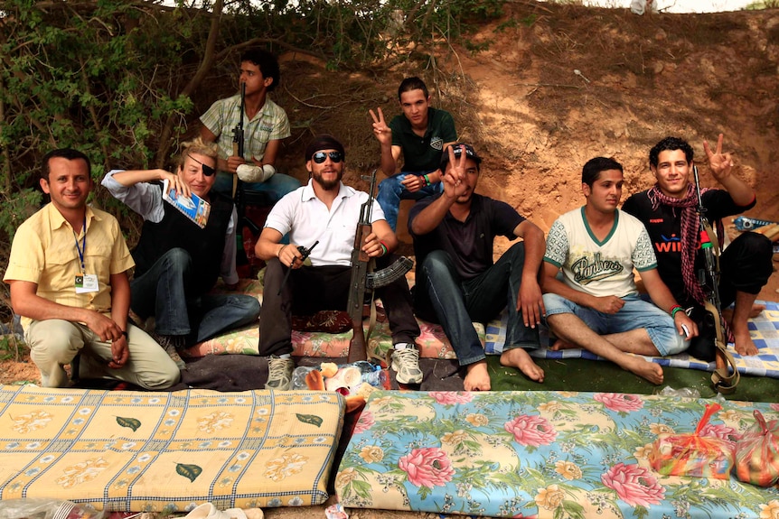 Sunday Times war correspondent Marie Colvin (second left) poses with Libyan rebels in Misrata, 2011. (Reuters: Zohra Bensemra)