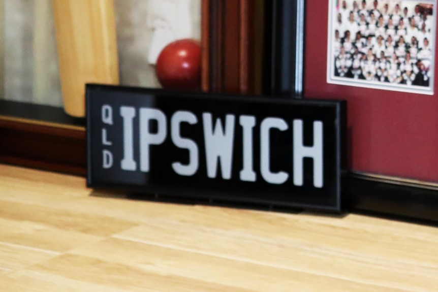 Black and white Queensland vehicle numberplate 'IPSWICH', held at Ipswich City Council.