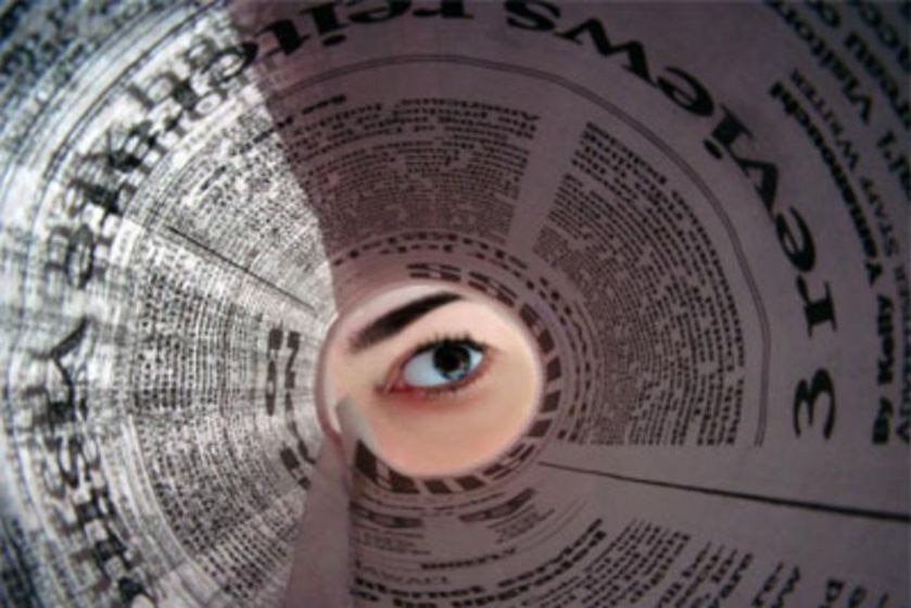 Eye looks up the centre of a newspaper spiral