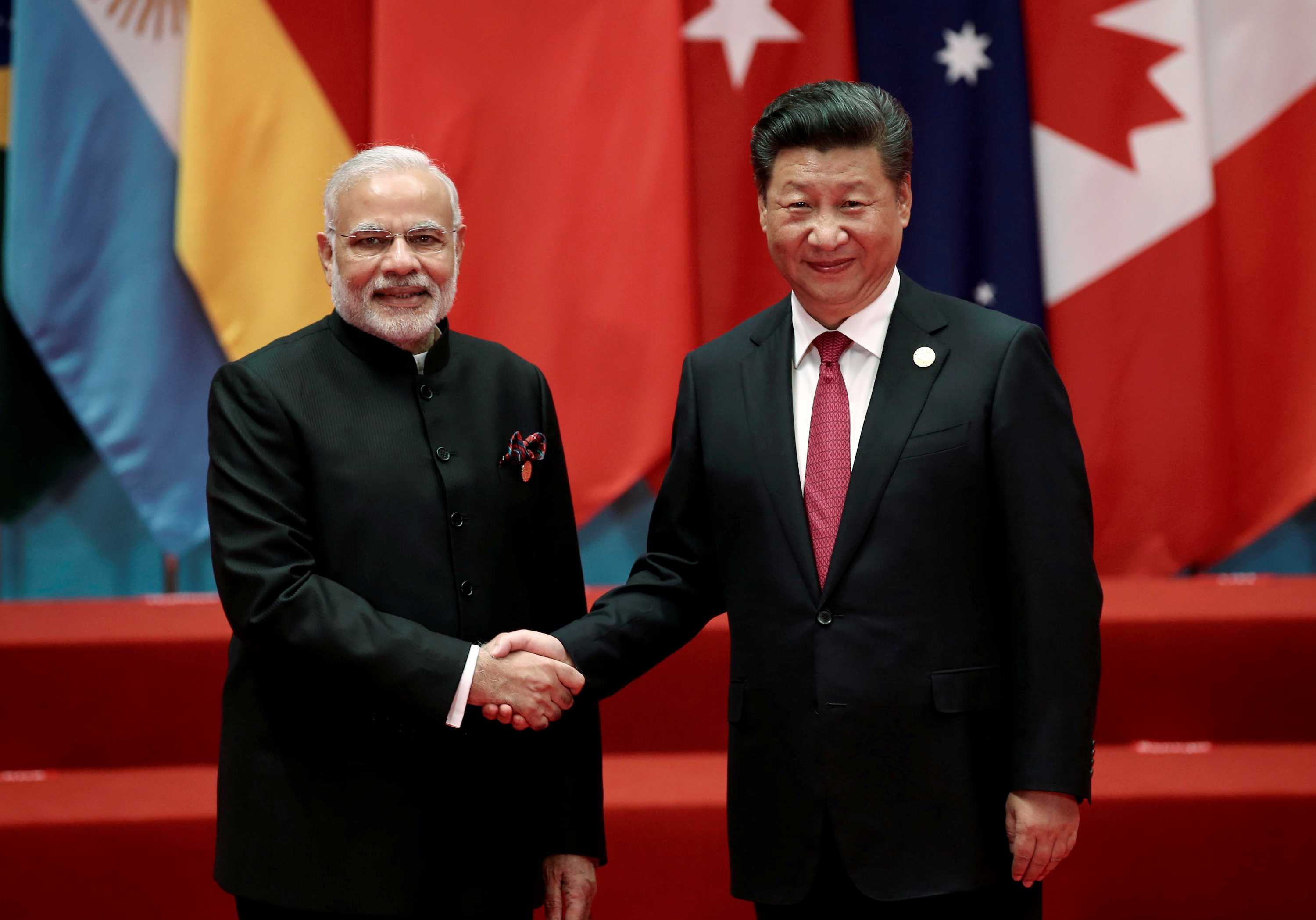 Chinese President Xi Jinping shakes hands with Indian Prime Minister Narendra Modi.
