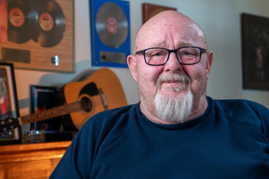  A portrait of a man with a grey goatee and black-rimmed glasses