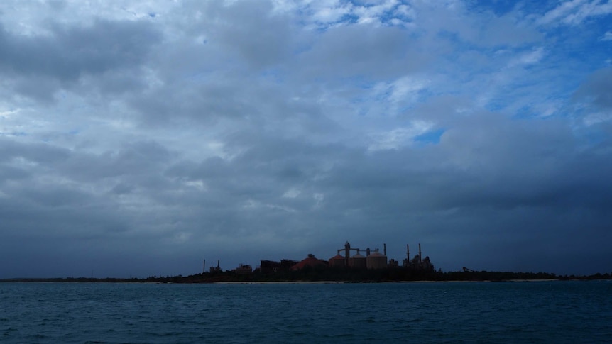 The Gove refinery seen from a distance across a body of water.