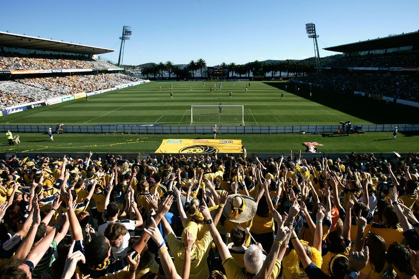 Mariners fans celebrate behind the goal during the round 11 match against the Victory