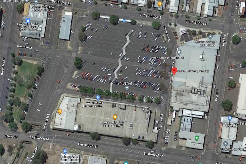 A satellite image showing a car park surrounded by buildings.