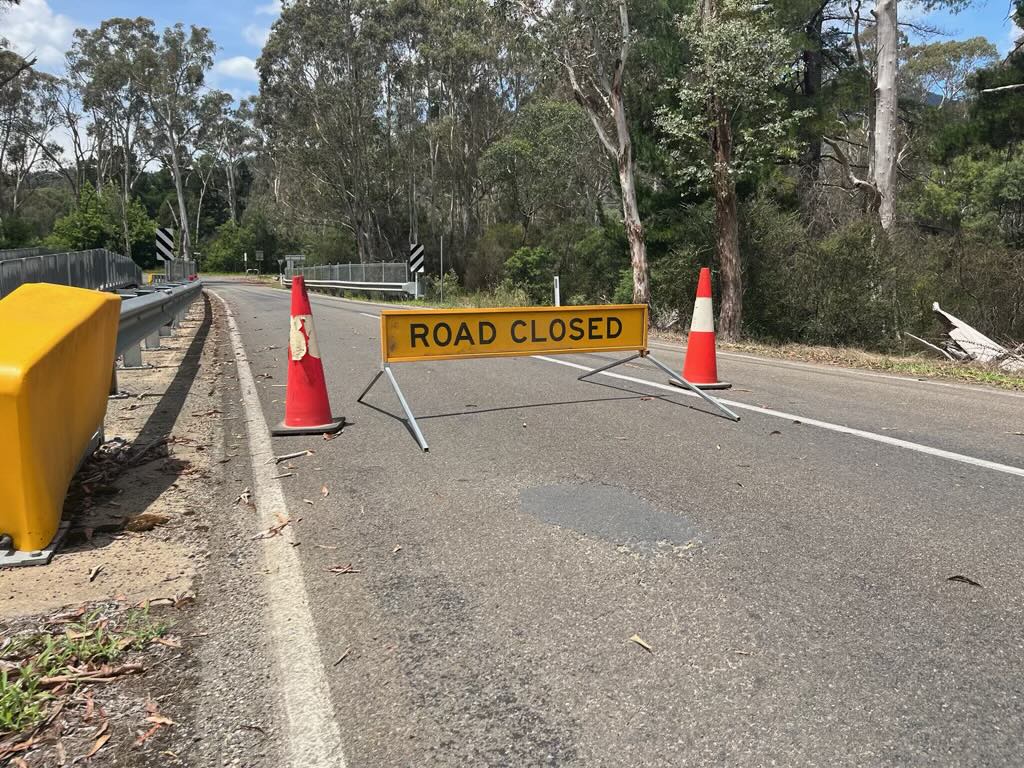 road closed sign on bridge.