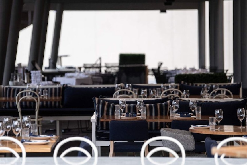 Empty tables at a restaurant in Campbells Cove in Sydney.