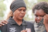 Three women at a vigil in Alice Springs.