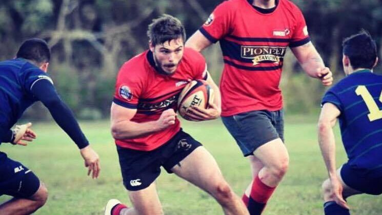 Rhys McNaughton playing rugby.