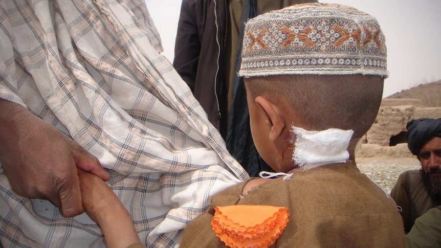 The back of a boy's head with a wound.