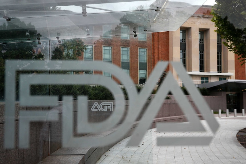 The US Food and Drug Administration building is see behind FDA logos at a bus stop on the agency's campus in Silver Spring, Md.
