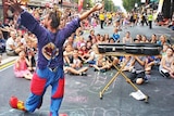 Clown warms up the crowd for the Fringe parade