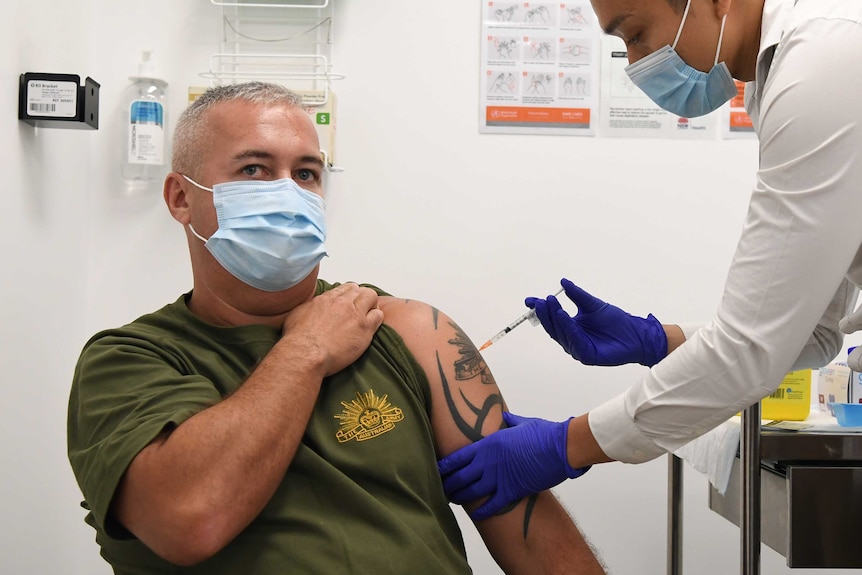 A member of the Defence Force gets an injection of the Pfizer COVID-19 vaccine.