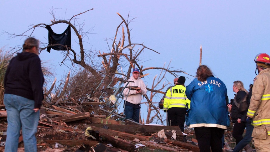 Residents of Elgin Avenue sort through debris after a tornado struck in Washington, Illinois.