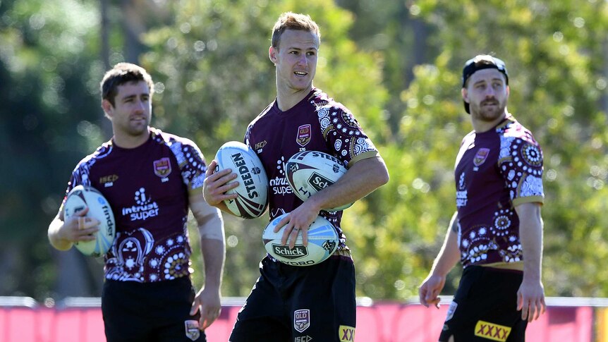 Andrew McCullough (L), Daly Cherry-Evans (C) and Cameron Munster tossing around footballs at Maroons State of Origin training.