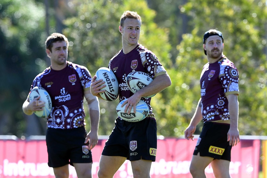 Andrew McCullough (L), Daly Cherry-Evans (C) and Cameron Munster tossing around footballs at Maroons State of Origin training.