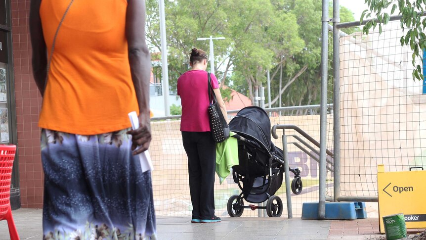 A mother with a pram tries to navigate construction works