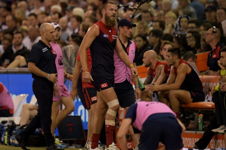 Max Gawn leaves the field with a hamstring injury against the Cats on Saturday night.