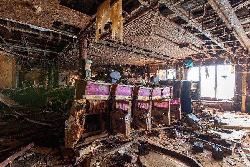 Water-damaged casino area, with debris strewn everywhere.