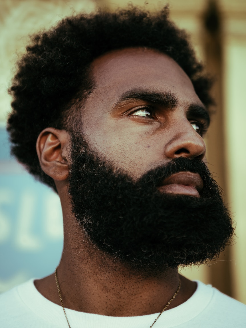 A close up portrait of a man looking sideways.