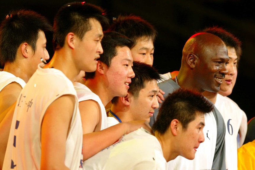 Michael Jordan poses for a picture in Beijing with Chinese basketball players.