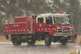 A red CFA truck in the rain.